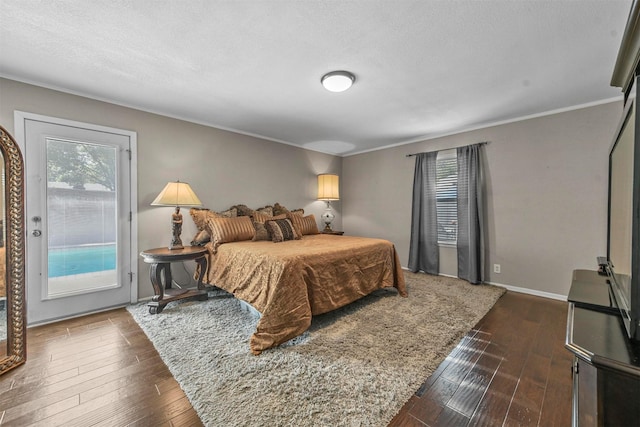 bedroom featuring access to exterior, a textured ceiling, baseboards, and dark wood-type flooring