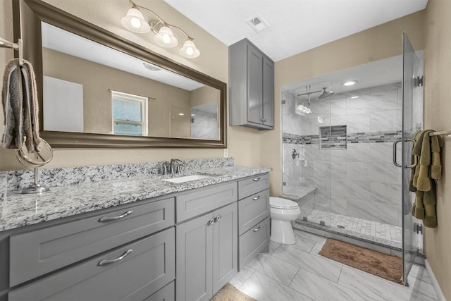 full bathroom featuring toilet, visible vents, vanity, marble finish floor, and a stall shower