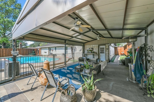 view of patio / terrace featuring a fenced in pool, fence, and a ceiling fan