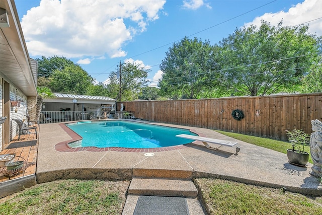 view of pool featuring a fenced backyard, a diving board, a fenced in pool, and a patio