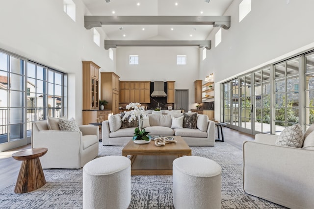 living room with beamed ceiling, recessed lighting, and a wealth of natural light