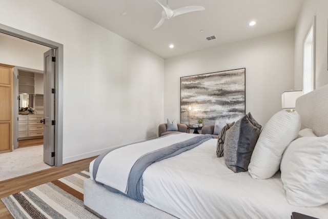 bedroom featuring recessed lighting, visible vents, a spacious closet, and light wood finished floors