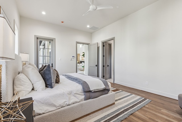 bedroom featuring recessed lighting, visible vents, baseboards, and wood finished floors