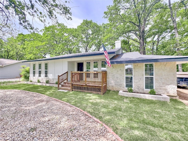 1345 Tawakoni Dr, West Tawakoni, TX 75474 - rear view of house with a chimney, a yard, and stone siding