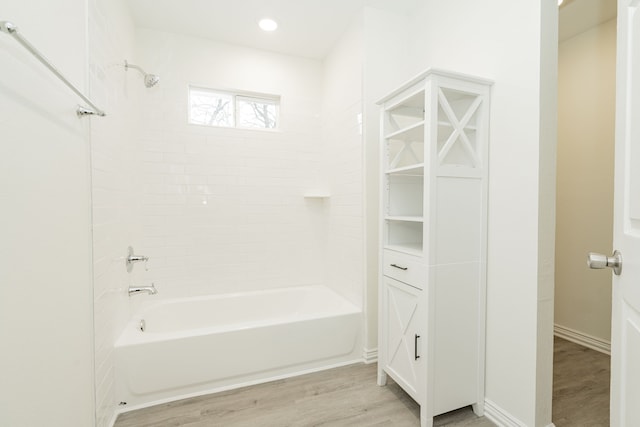 full bath featuring bathtub / shower combination, baseboards, wood finished floors, and recessed lighting