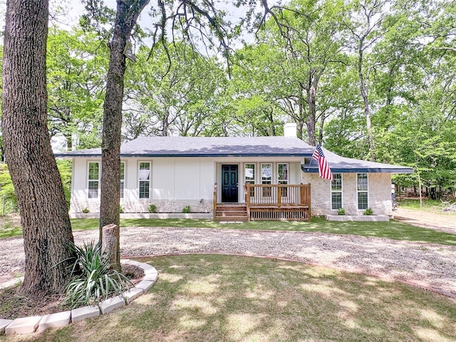 1345 Tawakoni Dr, West Tawakoni, TX 75474 - ranch-style home with a chimney, a front lawn, and curved driveway