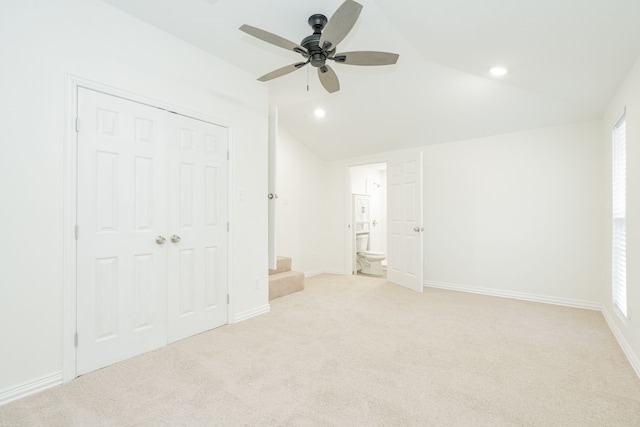 1345 Tawakoni Dr, West Tawakoni, TX 75474 - unfurnished bedroom with light colored carpet, ensuite bath, lofted ceiling, and baseboards