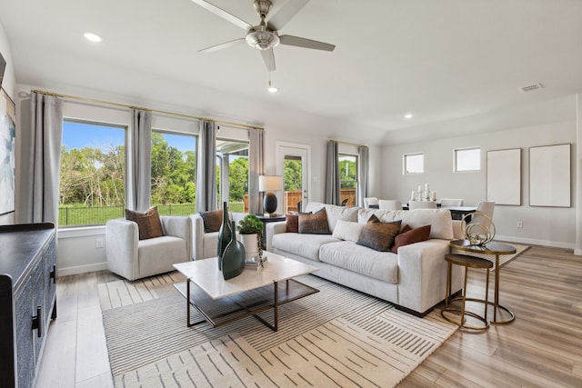 living room featuring baseboards, visible vents, ceiling fan, light wood-type flooring, and recessed lighting