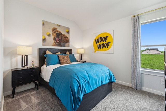 bedroom featuring lofted ceiling, baseboards, multiple windows, and dark carpet