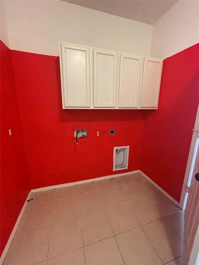 clothes washing area with hookup for a washing machine, cabinet space, hookup for an electric dryer, and baseboards