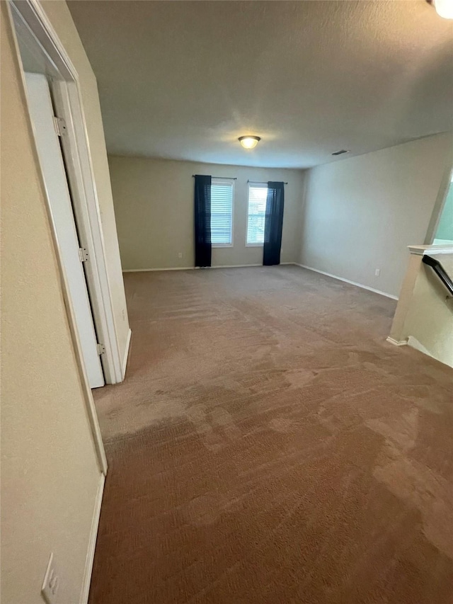 interior space featuring carpet, visible vents, and baseboards