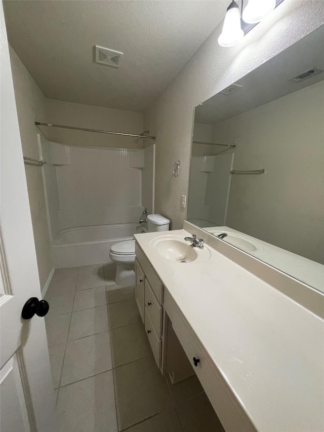 bathroom with toilet, tile patterned flooring, visible vents, and a textured ceiling