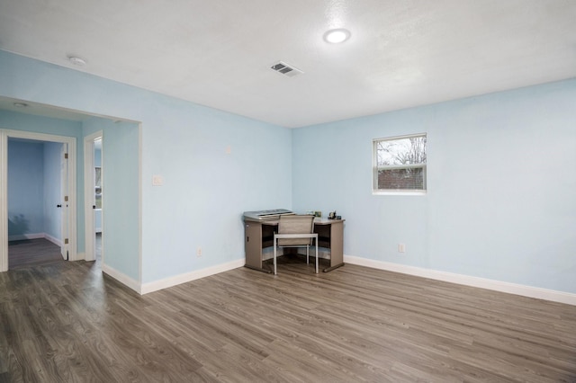 office featuring visible vents, baseboards, and dark wood-type flooring