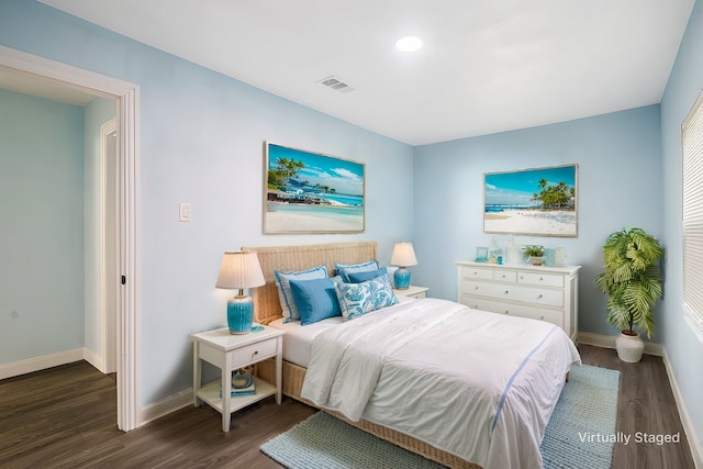 bedroom with baseboards, visible vents, and dark wood-type flooring