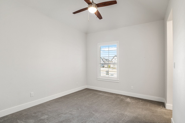 carpeted spare room featuring vaulted ceiling, a ceiling fan, and baseboards