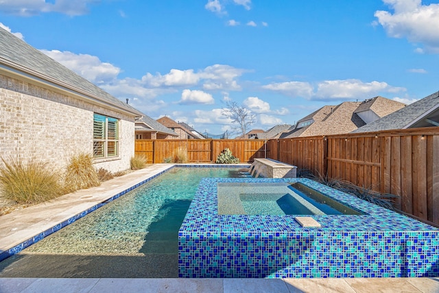 view of pool with an in ground hot tub, a fenced backyard, and a fenced in pool