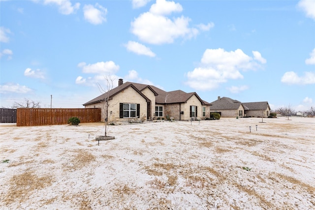 rear view of property featuring fence and a chimney