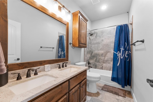 full bath with visible vents, a sink, toilet, and shower / bath combo with shower curtain