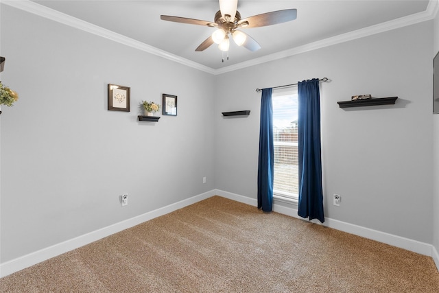 carpeted empty room with baseboards, ceiling fan, and crown molding