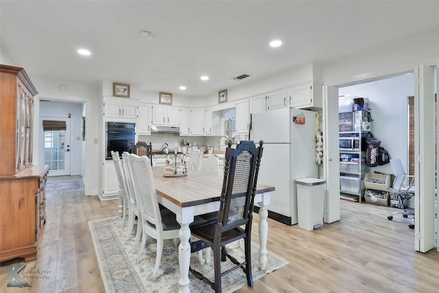 dining area featuring recessed lighting, visible vents, and light wood finished floors