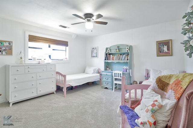 bedroom with light carpet, ceiling fan, and visible vents