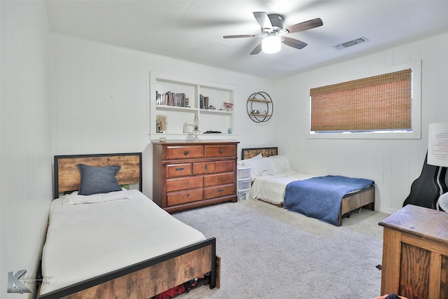 bedroom featuring visible vents, ceiling fan, and light carpet