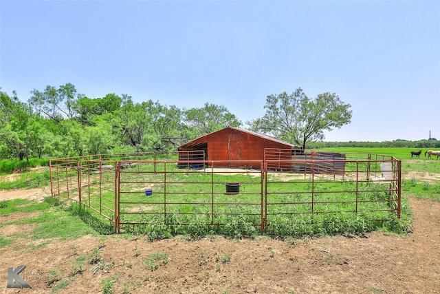 exterior space with an outbuilding, a rural view, and an exterior structure