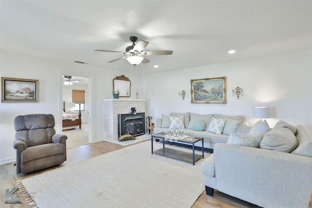 living area with ceiling fan, visible vents, wood finished floors, and recessed lighting