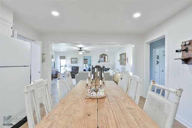 dining area with ceiling fan, a fireplace, and recessed lighting