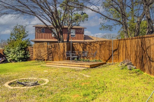 view of yard with a fenced backyard and a wooden deck