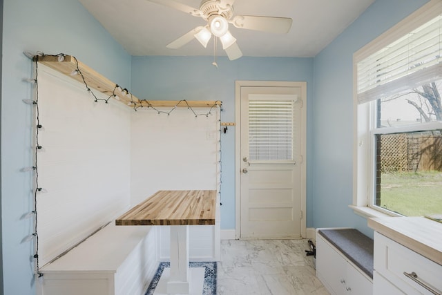 mudroom featuring marble finish floor, ceiling fan, and baseboards