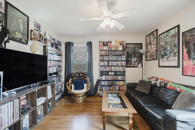 living room with wood finished floors and a ceiling fan