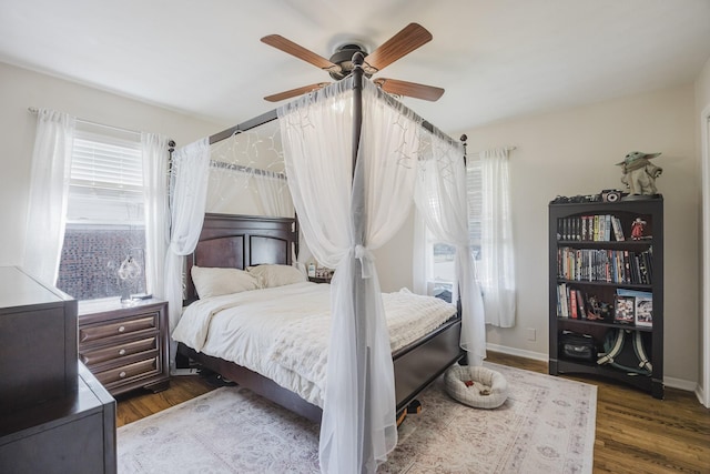 bedroom with baseboards, a ceiling fan, and wood finished floors