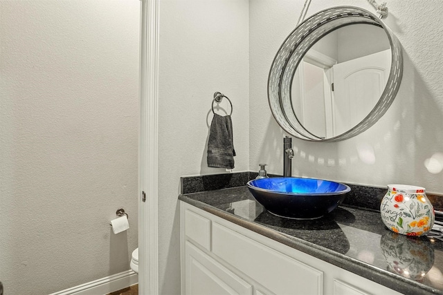 8500 Cobble Stone, Godley, TX 76044 - half bath featuring a textured wall, vanity, and toilet