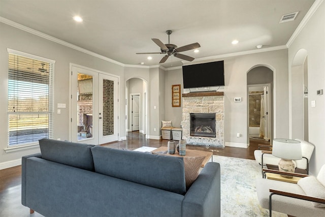 8500 Cobble Stone, Godley, TX 76044 - living area featuring arched walkways, ornamental molding, baseboards, a fireplace, and a ceiling fan