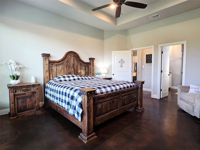 bedroom featuring visible vents, baseboards, concrete flooring, and a high ceiling