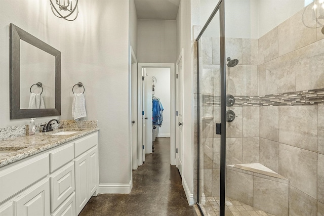 8500 Cobble Stone, Godley, TX 76044 - full bathroom with a stall shower, baseboards, concrete flooring, a walk in closet, and vanity