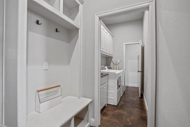 mudroom featuring finished concrete flooring and washing machine and dryer