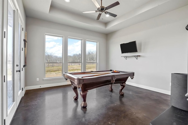 playroom with baseboards, billiards, a raised ceiling, and finished concrete flooring