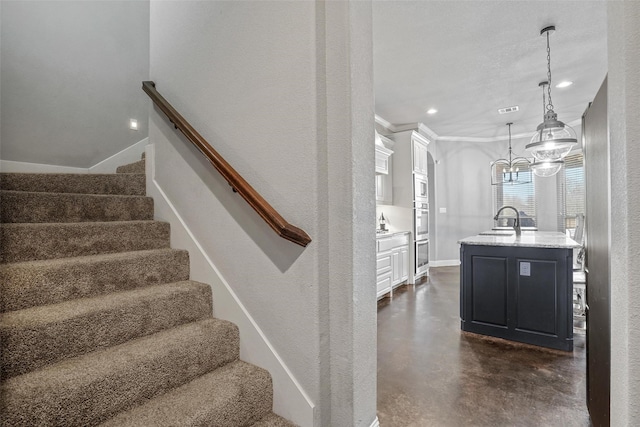stairway featuring finished concrete flooring, baseboards, recessed lighting, and visible vents