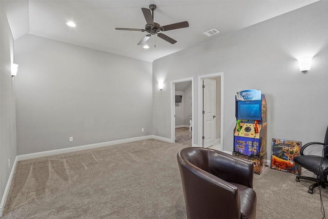 sitting room featuring baseboards, visible vents, light colored carpet, ceiling fan, and vaulted ceiling