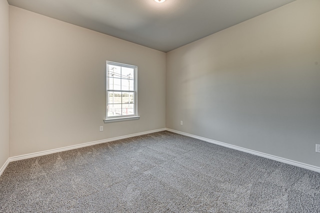 carpeted empty room with baseboards