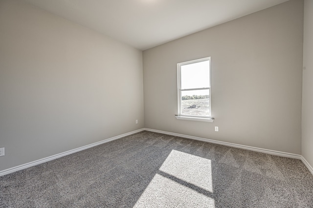 empty room with carpet and baseboards