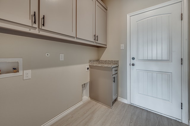 laundry room featuring cabinet space, baseboards, light wood-type flooring, washer hookup, and electric dryer hookup