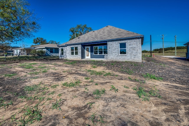 rear view of property featuring brick siding