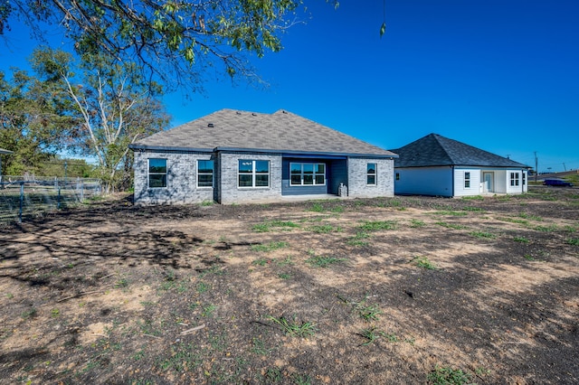 rear view of property with fence