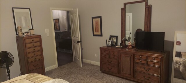 carpeted bedroom featuring baseboards