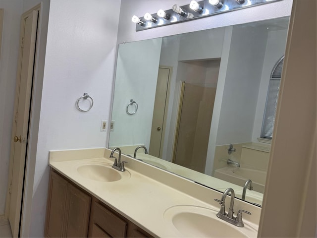 full bath with double vanity, a garden tub, and a sink