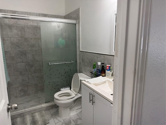 full bath featuring toilet, marble finish floor, vanity, a shower stall, and tile walls