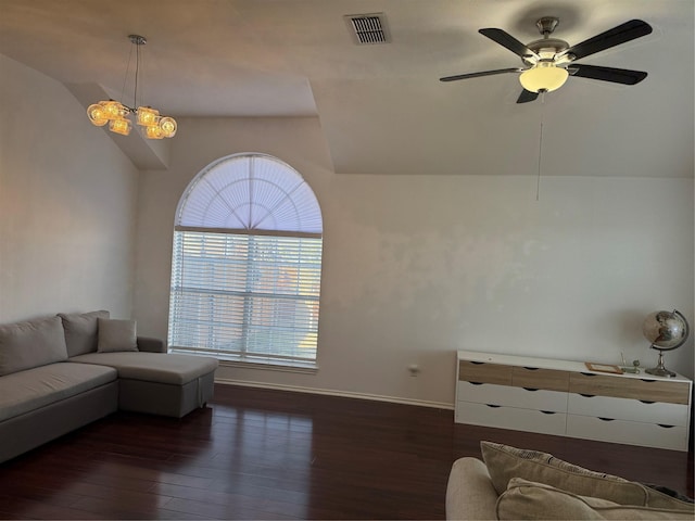 living area featuring dark wood-style floors, visible vents, a ceiling fan, vaulted ceiling, and baseboards